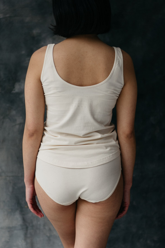 Woman wearing organic cotton maternity tank and briefs set