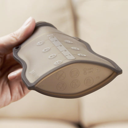 Flexible silicone food pouch showing measurement markings and temperature-safe material icons