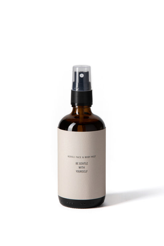 Amber glass spray bottle of natural neroli body mist for toning and hydrating skin