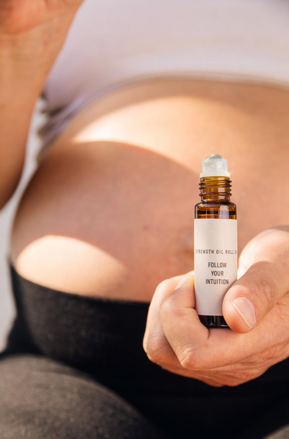 Expectant mother with aromatherapy oil for pregnancy stress relief
