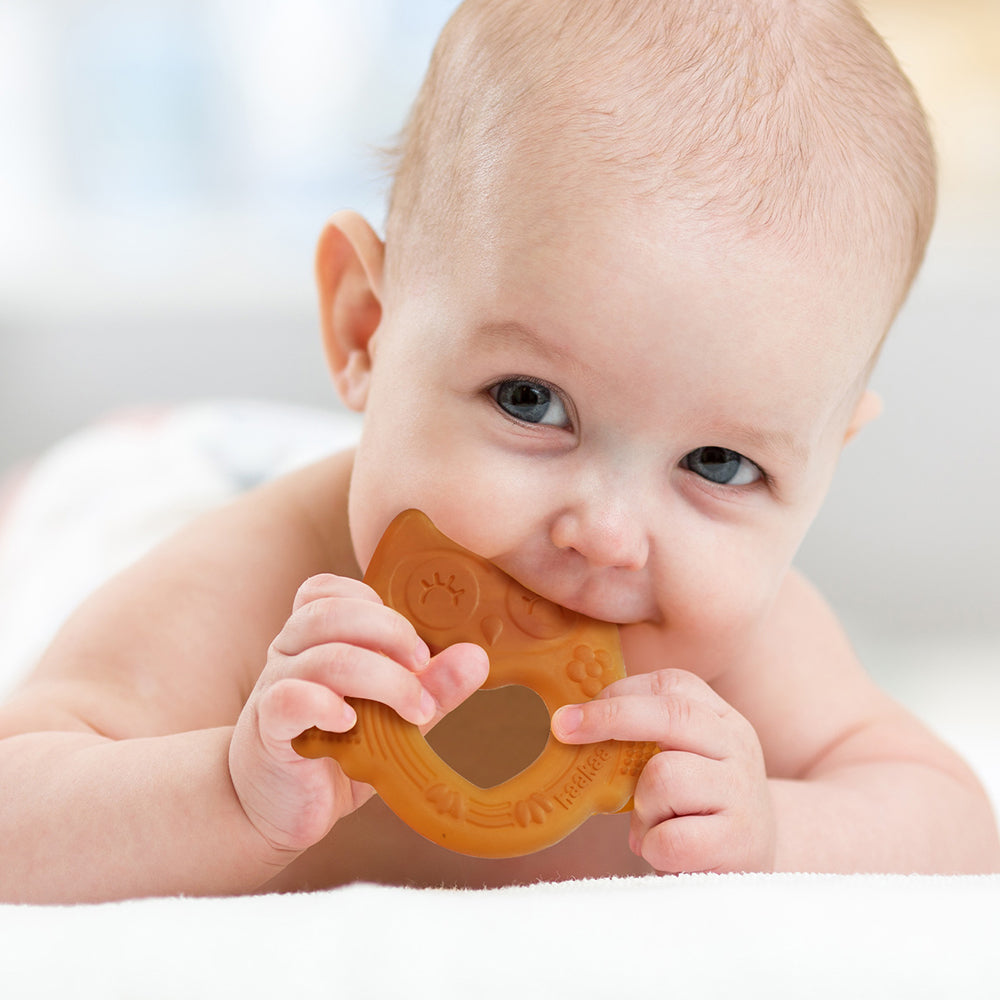 Infant holding BPA-free silicone teething toy with textured surface